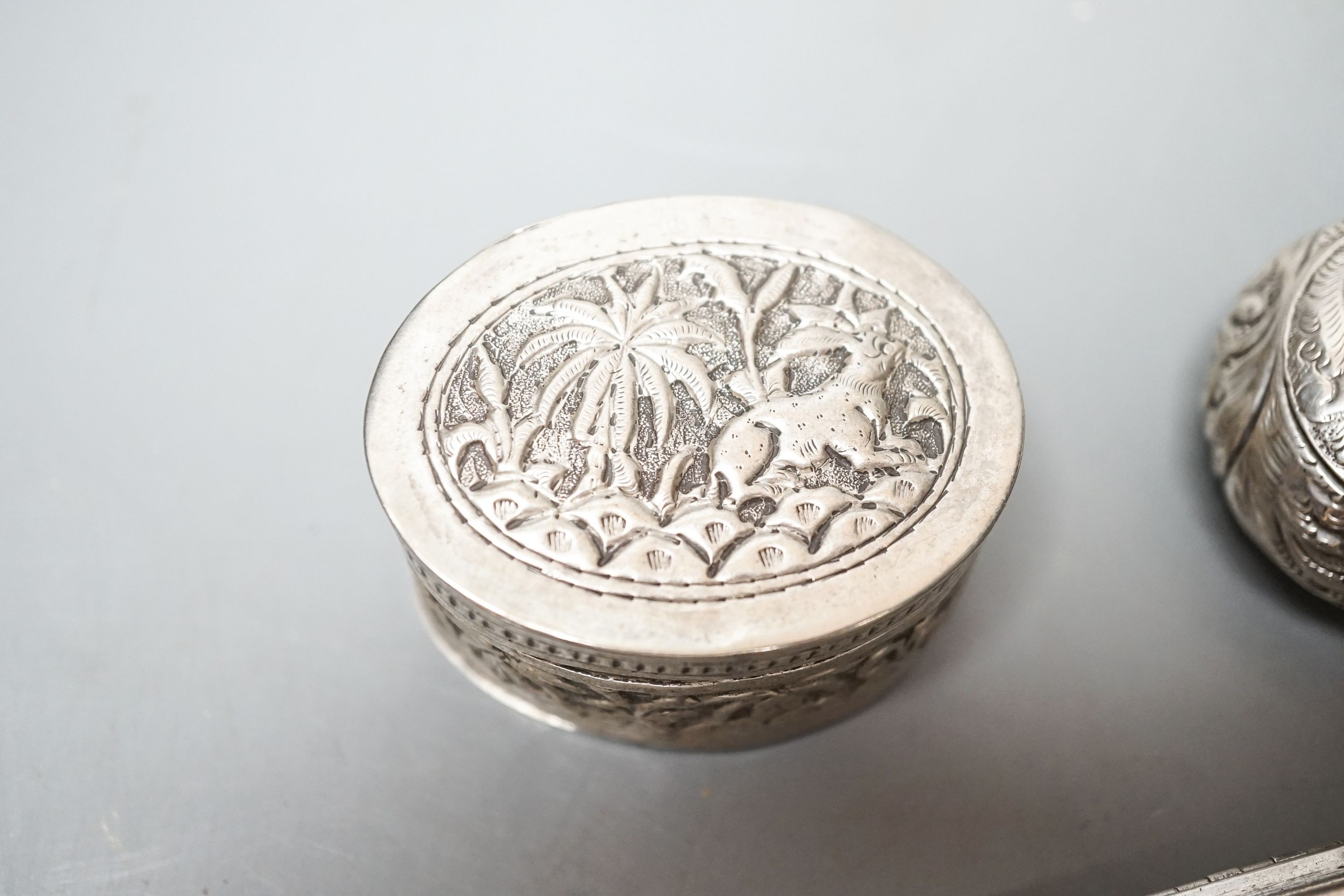 A selection of three small silver or white metal boxes to include a tortoiseshell pique box and a silver and shell inlaid compact.